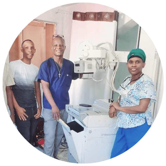 Biomedical technicians working on medical equipment at a partner hospital