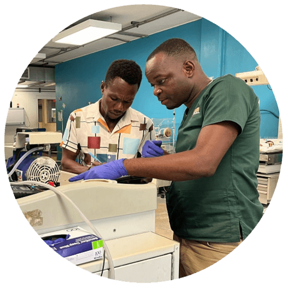 A biomedical technician repairing a medical device